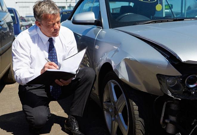 young man filling out paperwork for car insurance